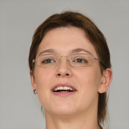 Joyful white adult female with medium  brown hair and grey eyes