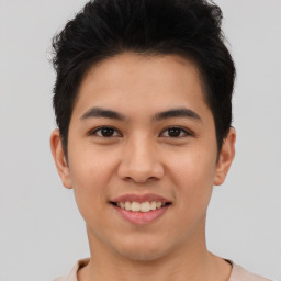 Joyful asian young-adult male with short  brown hair and brown eyes