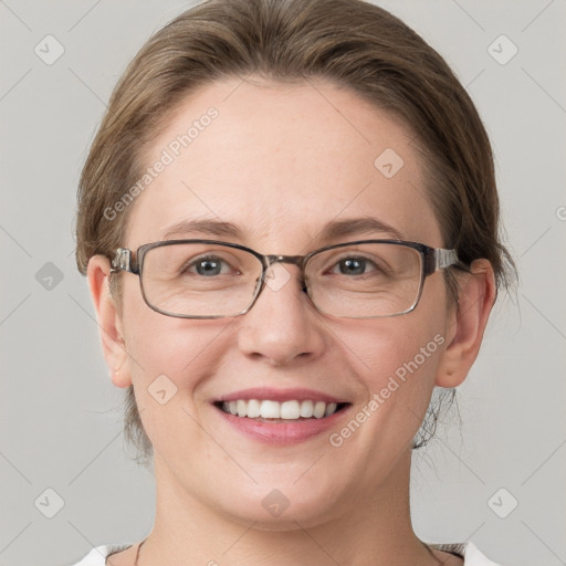 Joyful white adult female with medium  brown hair and grey eyes