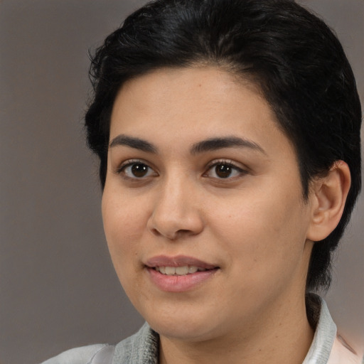 Joyful white young-adult female with medium  black hair and brown eyes