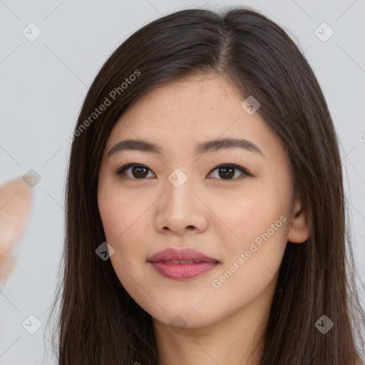 Joyful asian young-adult female with long  brown hair and brown eyes