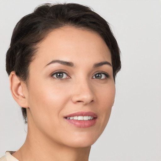 Joyful white young-adult female with short  brown hair and brown eyes