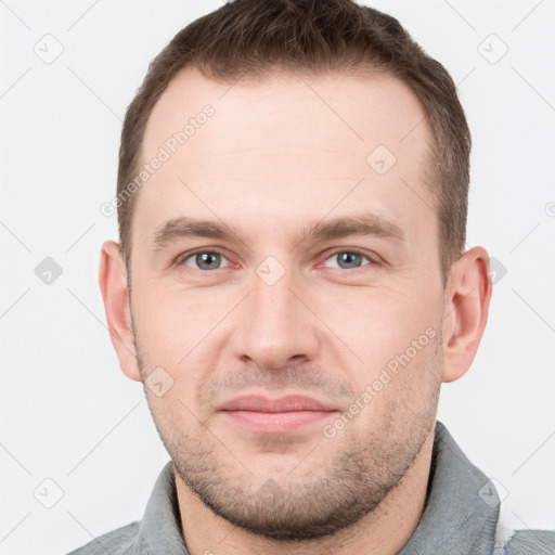 Joyful white young-adult male with short  brown hair and grey eyes