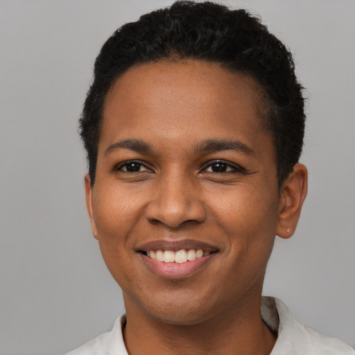 Joyful black young-adult female with short  brown hair and brown eyes