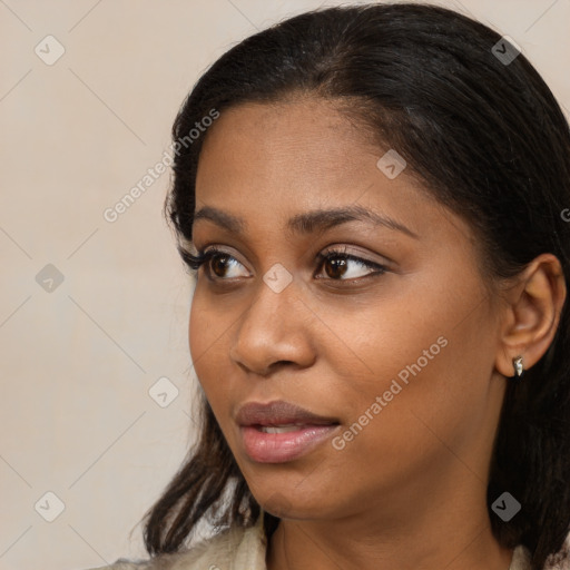 Joyful black young-adult female with medium  brown hair and brown eyes