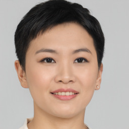 Joyful asian young-adult female with short  brown hair and brown eyes