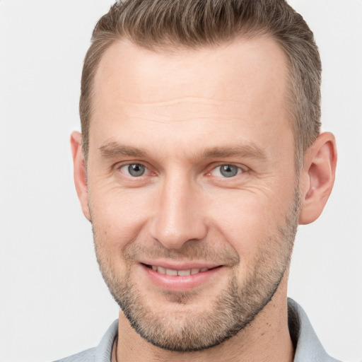 Joyful white adult male with short  brown hair and grey eyes