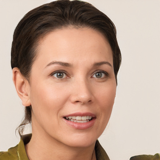 Joyful white young-adult female with short  brown hair and grey eyes