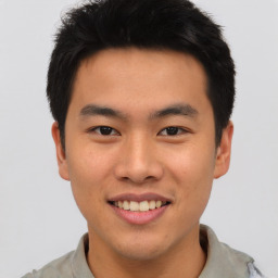 Joyful asian young-adult male with short  black hair and brown eyes