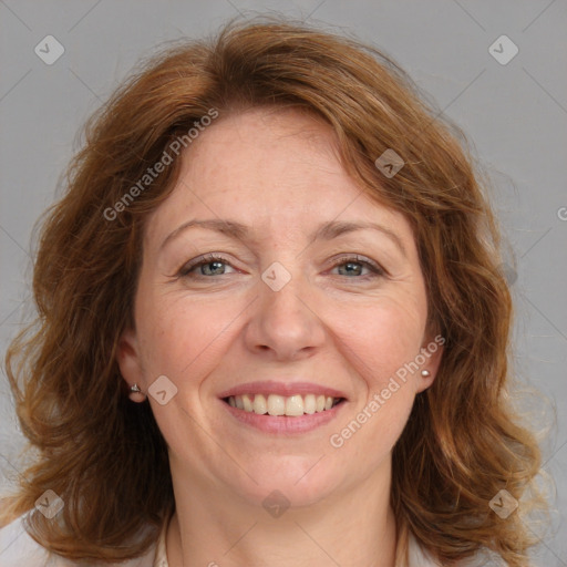 Joyful white adult female with medium  brown hair and grey eyes