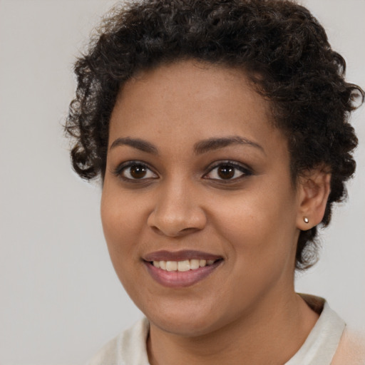 Joyful black young-adult female with short  brown hair and brown eyes