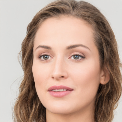 Joyful white young-adult female with long  brown hair and green eyes