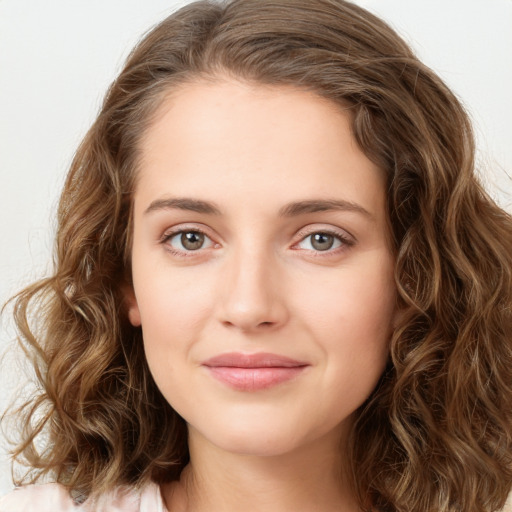 Joyful white young-adult female with long  brown hair and green eyes