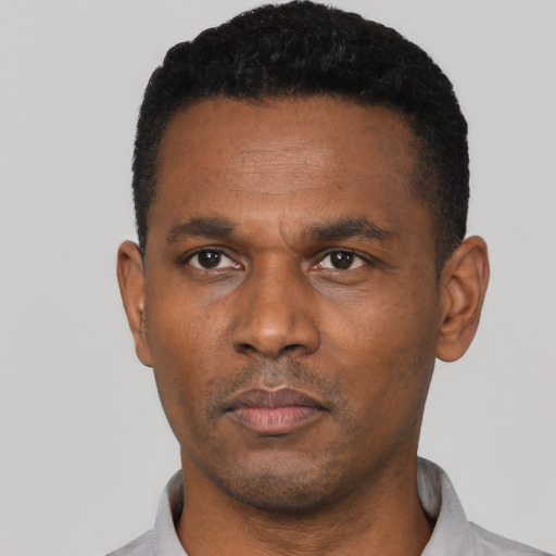 Neutral black adult male with short  black hair and brown eyes