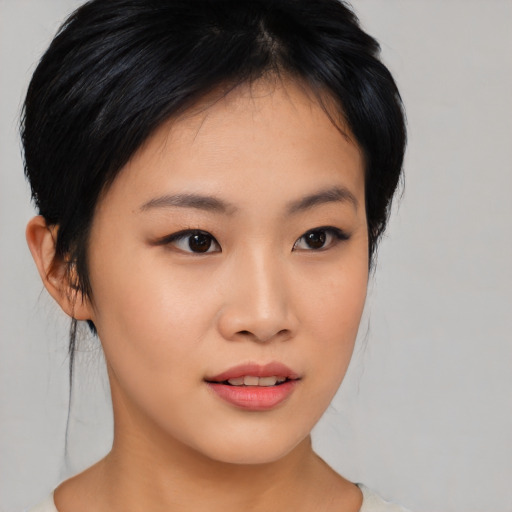 Joyful asian young-adult female with medium  black hair and brown eyes