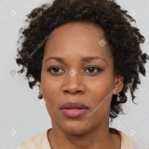 Joyful black adult female with short  brown hair and brown eyes