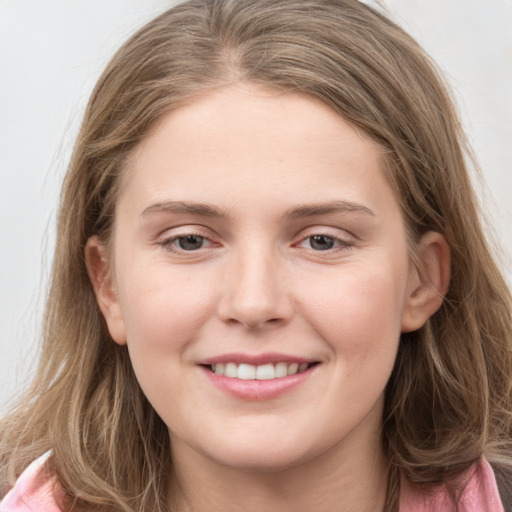 Joyful white young-adult female with long  brown hair and grey eyes