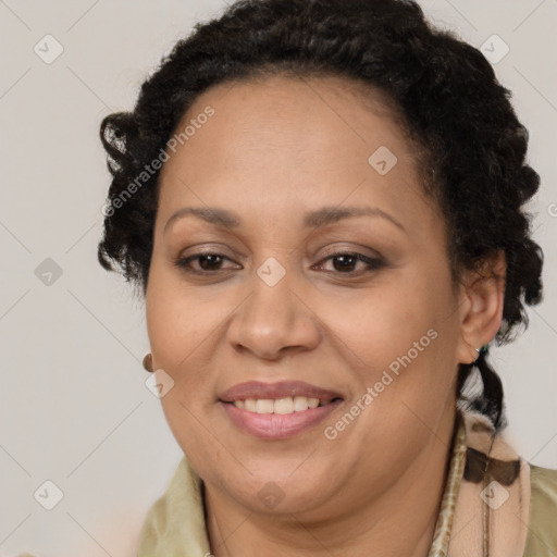 Joyful black adult female with long  brown hair and brown eyes