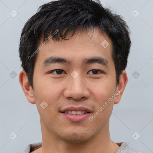 Joyful asian young-adult male with short  brown hair and brown eyes