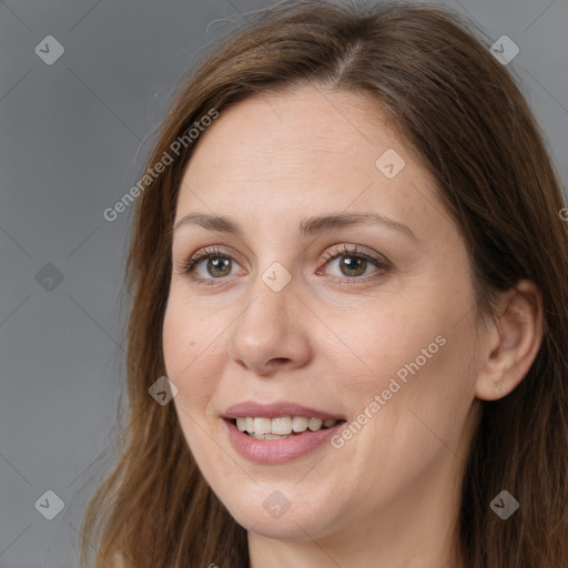 Joyful white adult female with long  brown hair and brown eyes