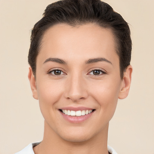 Joyful white young-adult female with short  brown hair and brown eyes