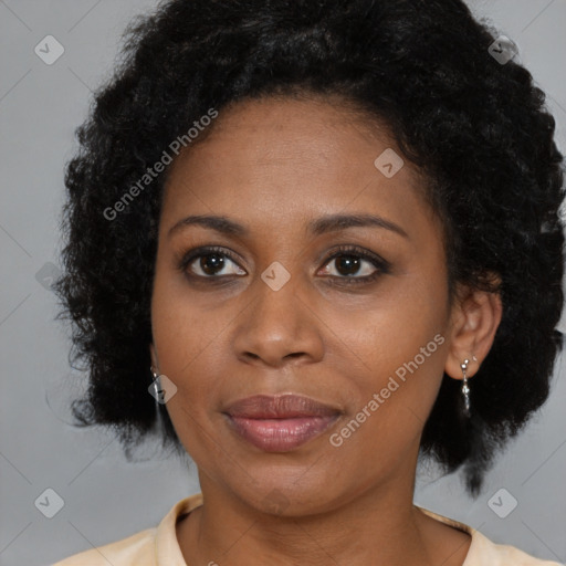 Joyful black adult female with medium  brown hair and brown eyes