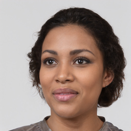 Joyful latino young-adult female with medium  black hair and brown eyes