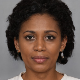 Joyful black adult female with short  brown hair and brown eyes