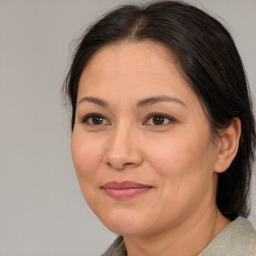 Joyful white adult female with medium  brown hair and brown eyes