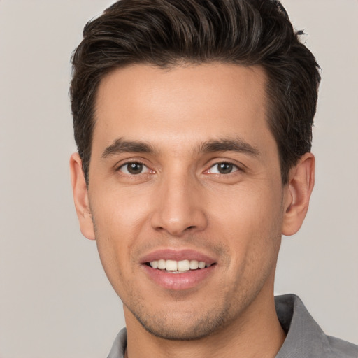 Joyful white young-adult male with short  brown hair and brown eyes