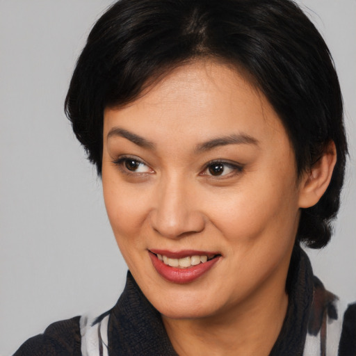 Joyful asian young-adult female with medium  black hair and brown eyes