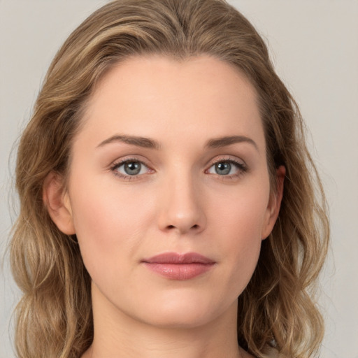 Joyful white young-adult female with long  brown hair and green eyes