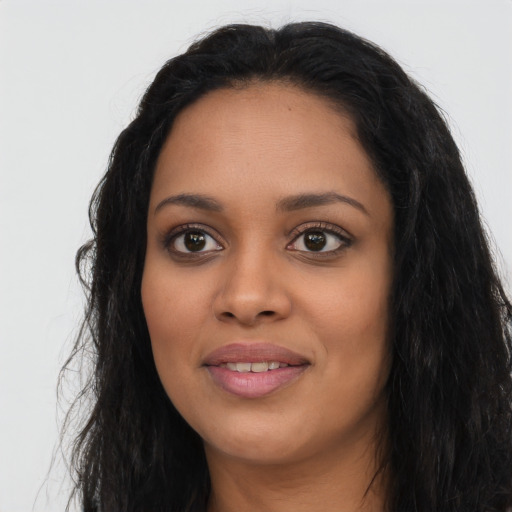 Joyful latino young-adult female with long  black hair and brown eyes