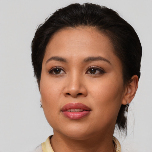 Joyful asian young-adult female with medium  brown hair and brown eyes