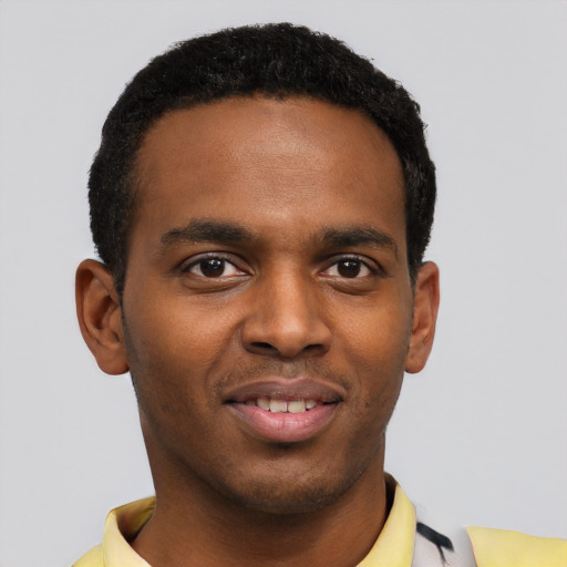 Joyful black young-adult male with short  black hair and brown eyes