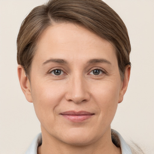 Joyful white adult female with short  brown hair and brown eyes