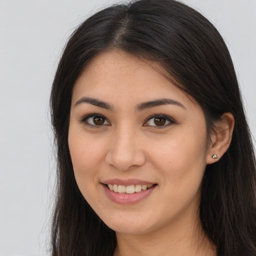 Joyful latino young-adult female with long  brown hair and brown eyes