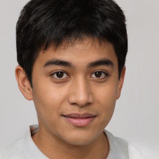 Joyful latino young-adult male with short  brown hair and brown eyes