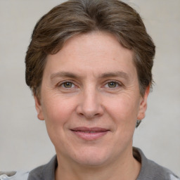 Joyful white adult female with short  brown hair and grey eyes