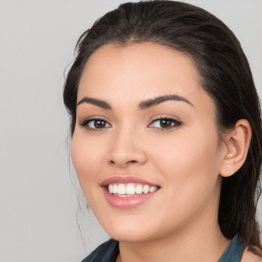 Joyful white young-adult female with medium  black hair and brown eyes