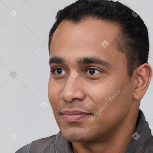 Joyful white young-adult male with short  black hair and brown eyes