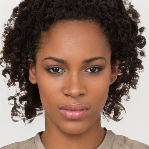 Neutral black young-adult female with medium  brown hair and brown eyes