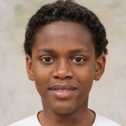 Joyful black child male with short  brown hair and brown eyes