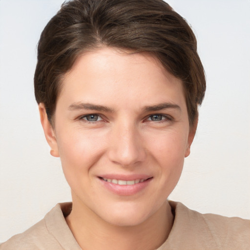 Joyful white young-adult female with short  brown hair and grey eyes