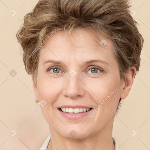 Joyful white adult female with short  brown hair and grey eyes