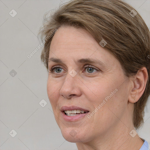 Joyful white adult female with medium  brown hair and grey eyes