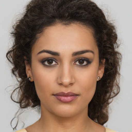Joyful latino young-adult female with long  brown hair and brown eyes