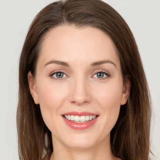 Joyful white young-adult female with long  brown hair and grey eyes