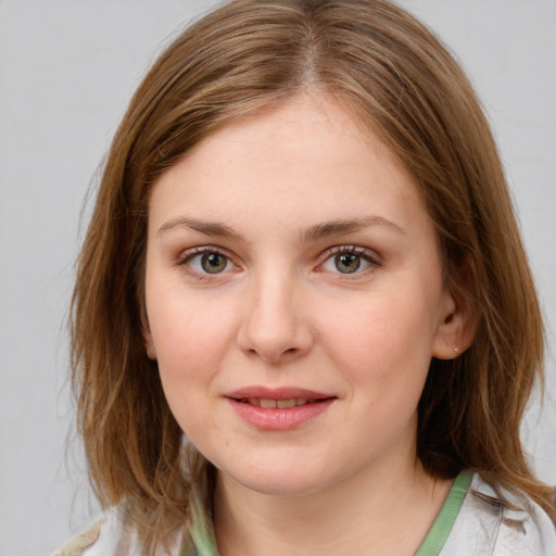 Joyful white young-adult female with medium  brown hair and blue eyes