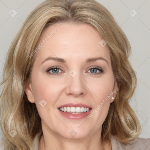 Joyful white adult female with long  brown hair and grey eyes